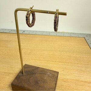 Purple red crystal embellished inside out hoop earrings with gold tone base